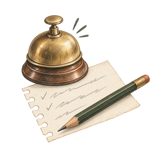 A brass desk bell with a handwritten reminder